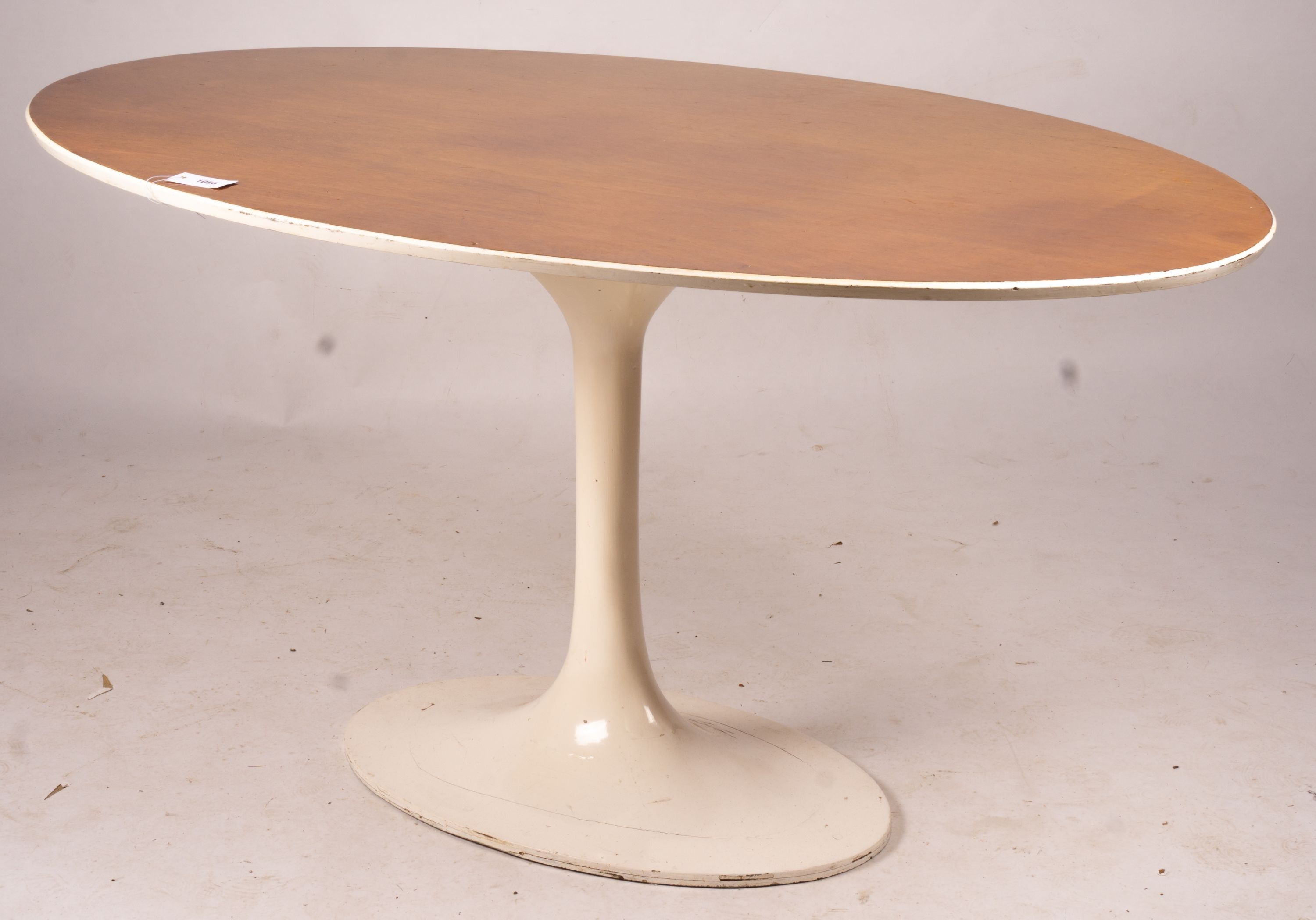 An Arkana style tulip base teak top oval dining table, length 152cm, depth 91cm, height 76cm